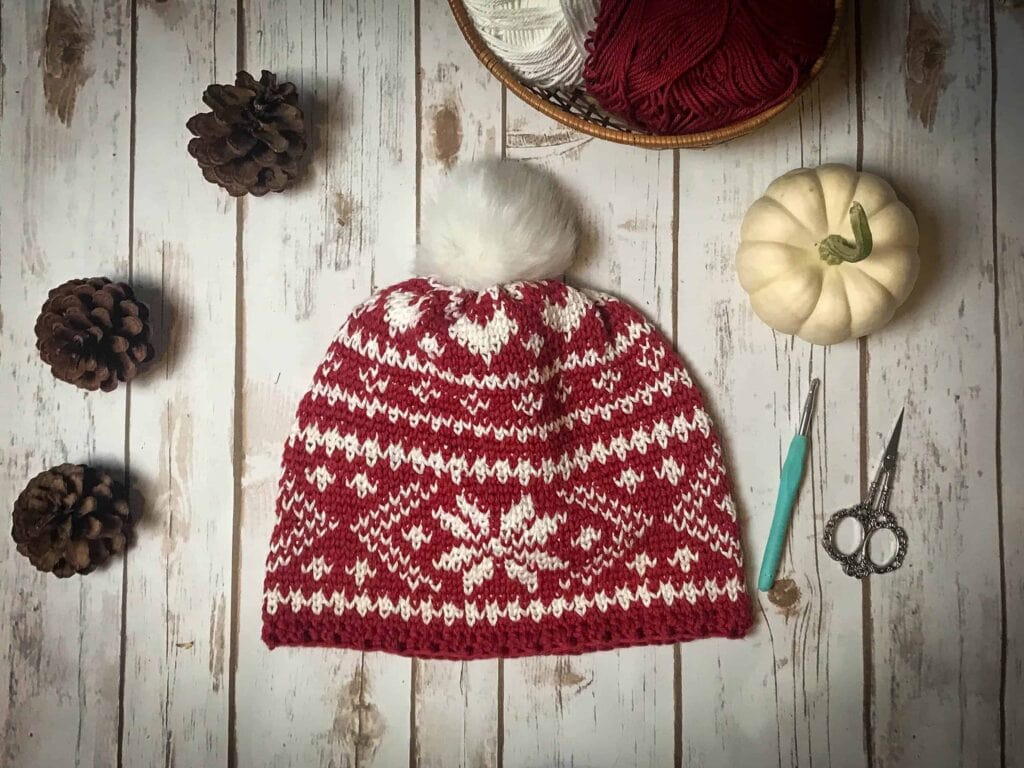 Fair Isle Crochet Beanie Pattern on a table with crochet hook and scissors