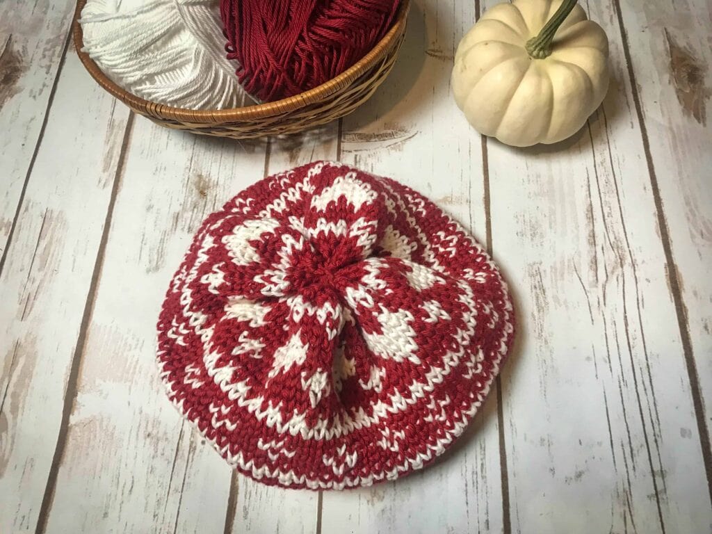 Fair Isle Crochet Beanie Pattern on a white table with white pumpkins