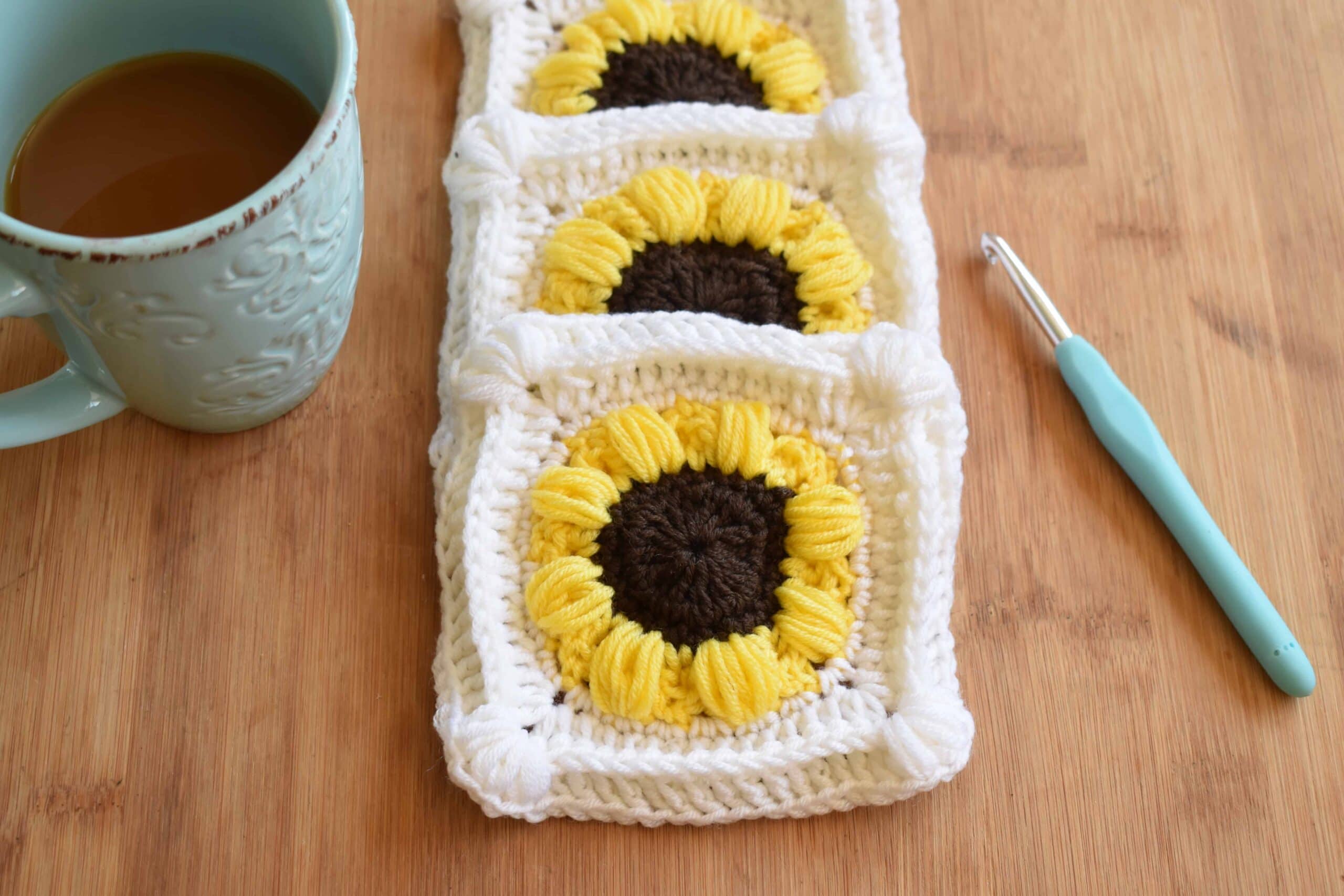 sunflower afghan crochet pattern in scheepjes merino soft with coffee cup and crochet hook