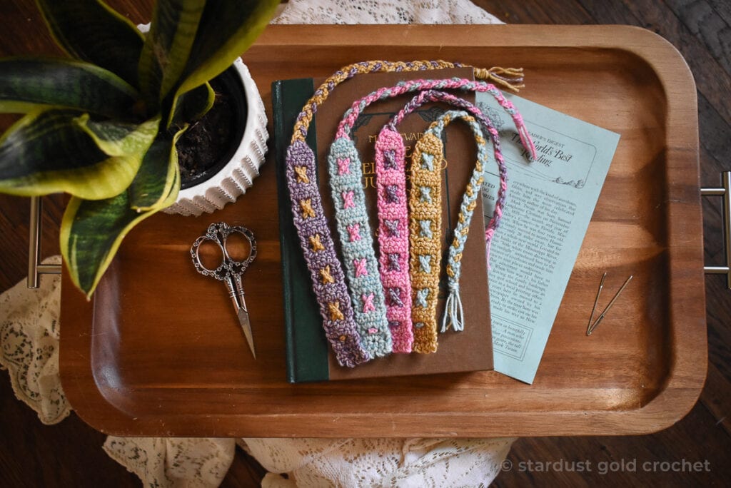 4 beautiful colorful crochet bookmarks on mark twain book